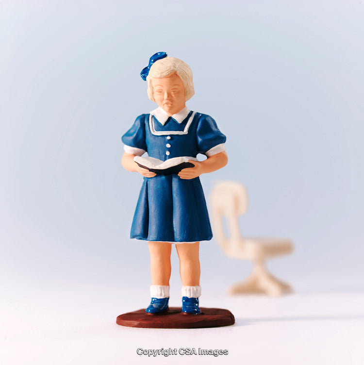Plastic Figurine Of A Young Girl Reading A Book