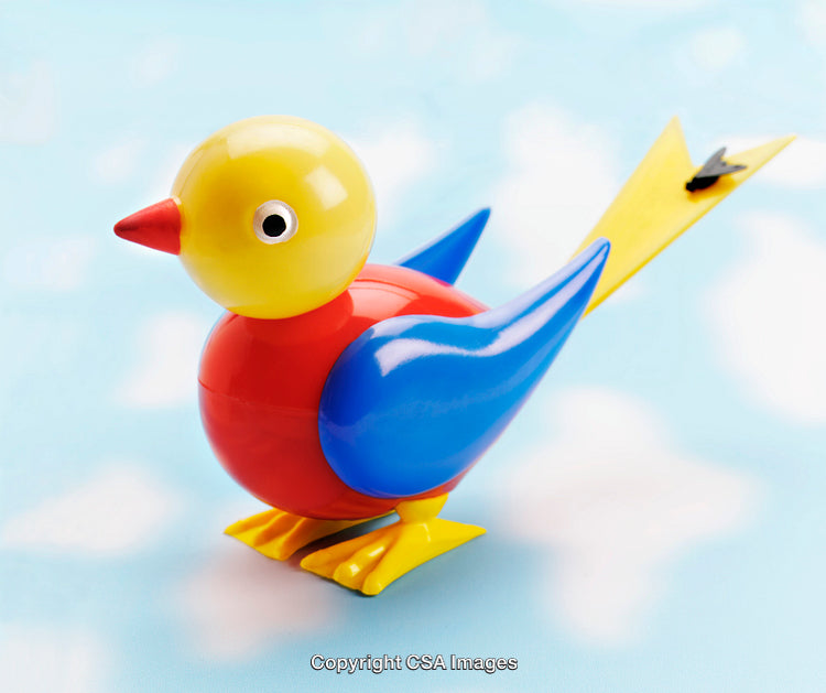 Vibrant Multicolored Plastic Bird Toy on a Sky Background