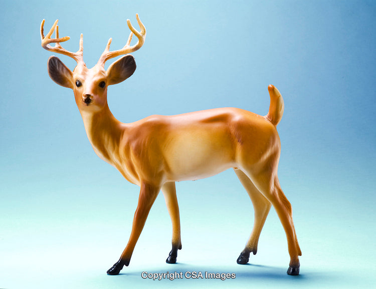 Realistic Plastic Deer Figurine Against a Gradient Blue Background