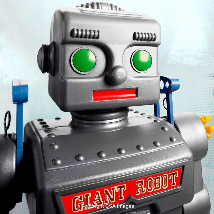 Close-Up of Retro Robot Figure with Green Eyes and Silver Body