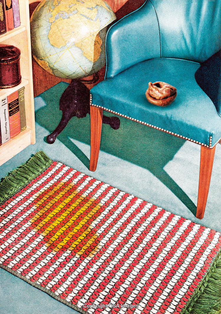 Mid-Century Interior with Globe, Armchair, and Bright Braided Rug