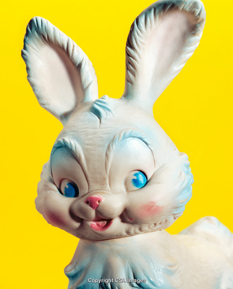Close-Up of a Smiling Toy Rabbit Against a Bright Yellow Background