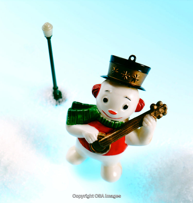 Festive Snowman Figurine with Guitar in Winter Snowy Scene