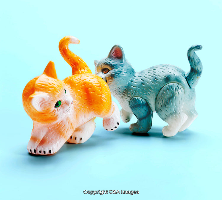 Colorful Plastic Cat Figurines on Blue Surface