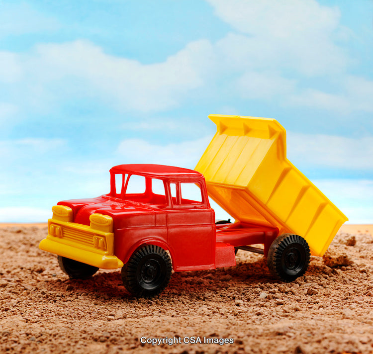 Brightly Colored Toy Dump Truck on a Sandy Outdoor Scene