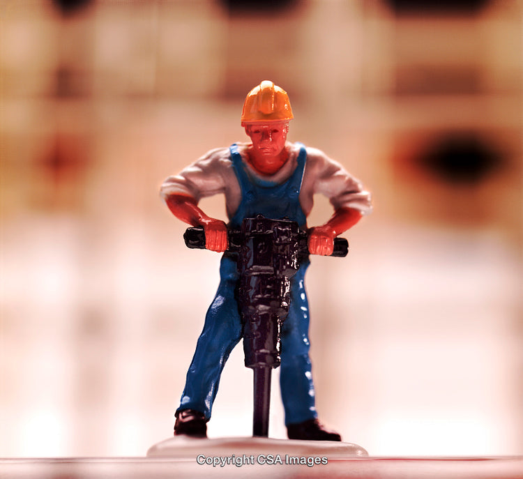 Construction Worker Toy Figure Using Jackhammer in Close-Up Detail
