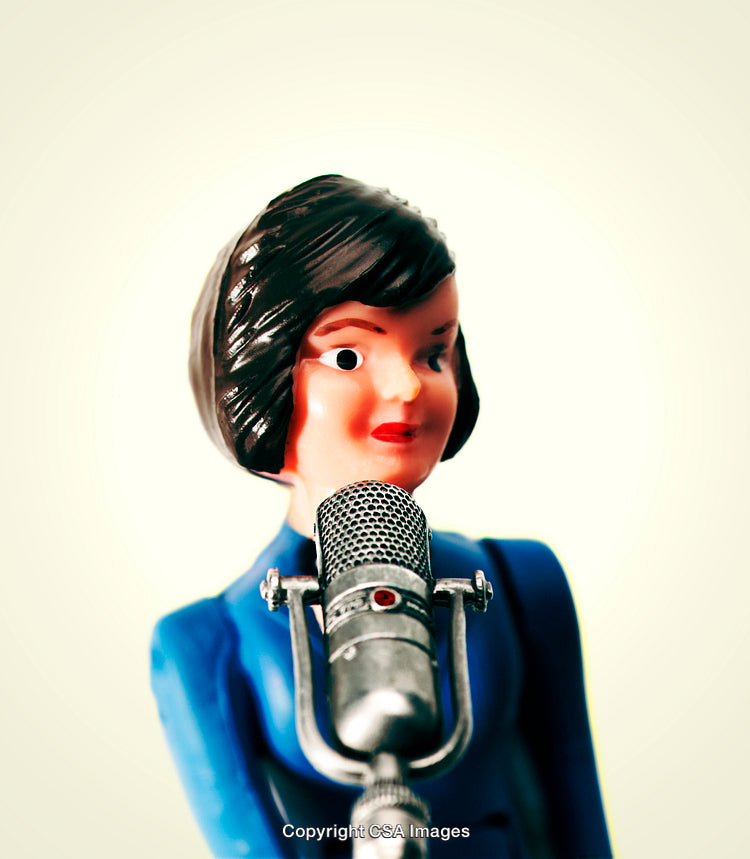 Retro Style Plastic Figure Speaking into Vintage Microphone in Focus