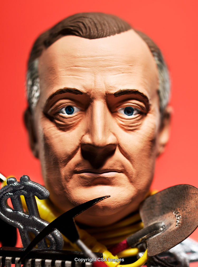 Close-Up of a Male Figurine With Bright Red Background and Dollar Symbol