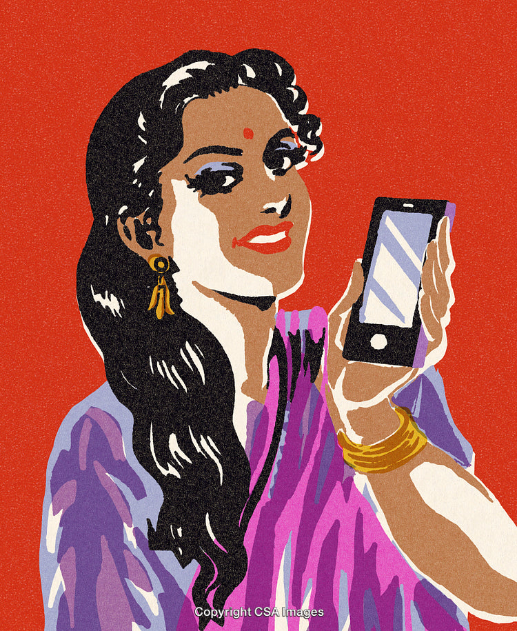 Modern Woman Wearing Saree Showing Smartphone Against Red Wall