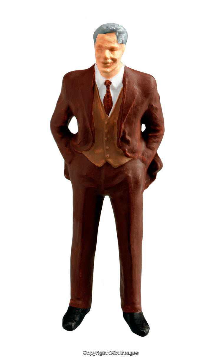 Miniature Figurine of a Man Wearing a Suit on White Background
