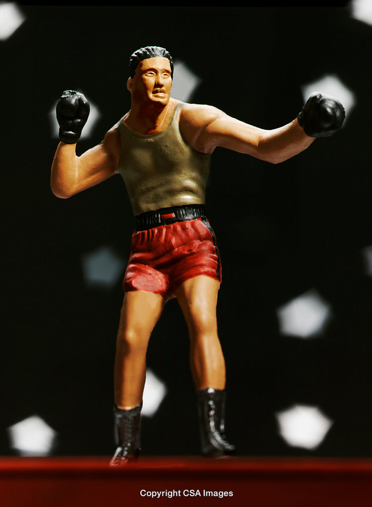Plastic Boxer Figurine in Fighting Stance with Dramatic Lighting