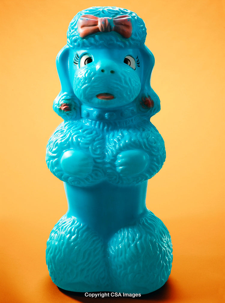 Colorful Retro Blue Dog Figurine on Bright Orange Background