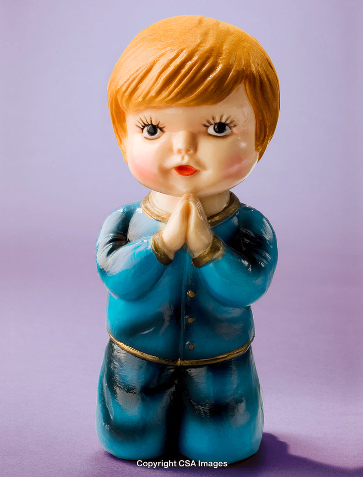 Ceramic Figurine of a Child In Prayer on Purple Background