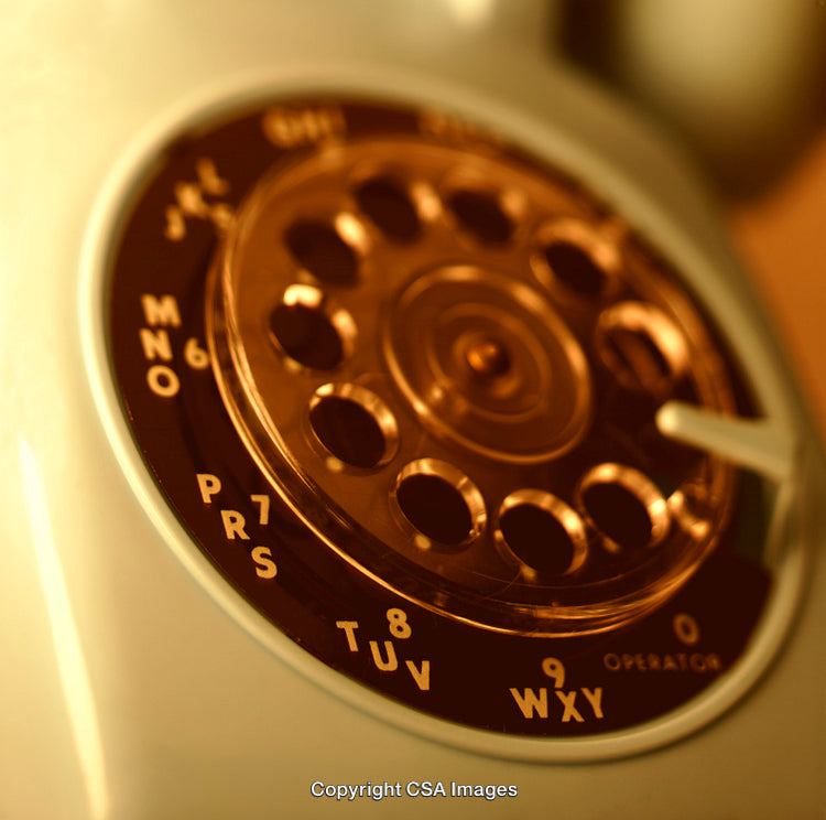 Close-Up of a Vintage Rotary Telephone Dial in Warm Lighting