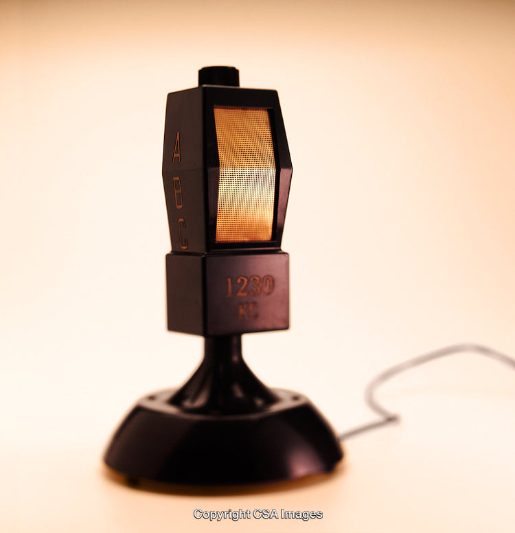 Vintage Black Plastic Toy Microphone with Unique Design in Warm Lighting