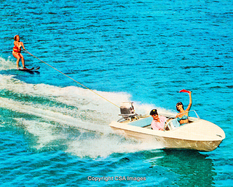 Couple on Speedboat with Waterskier on Blue Ocean Waters