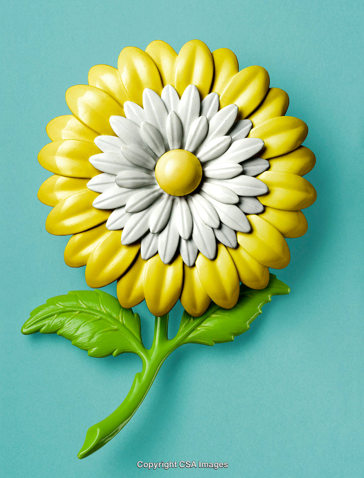 Brightly Colored Plastic Flower Realistically Shaped Against a Solid Teal Background