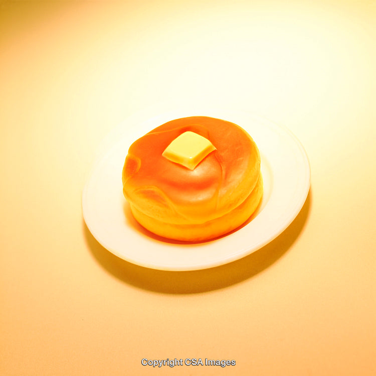 Yellow Pancake Toy on a Plate with Butter Highlighted by Warm Light