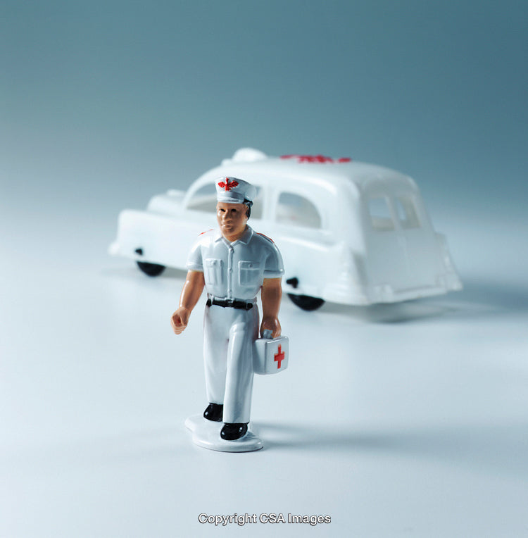 Plastic Medical Toy Figurine with Retro Themed Ambulance in a Studio Setting