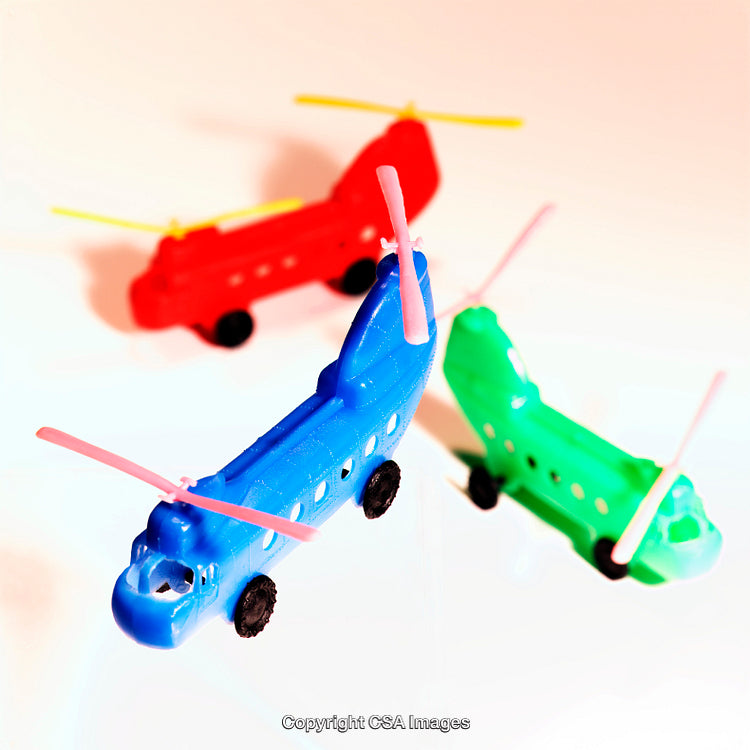 Colorful Plastic Toy Helicopters Displayed on a White Background