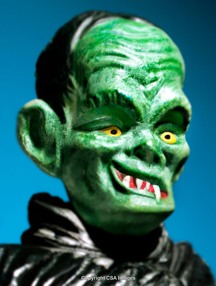 Close-Up of a Green Monster Toy Against Bright Blue Background