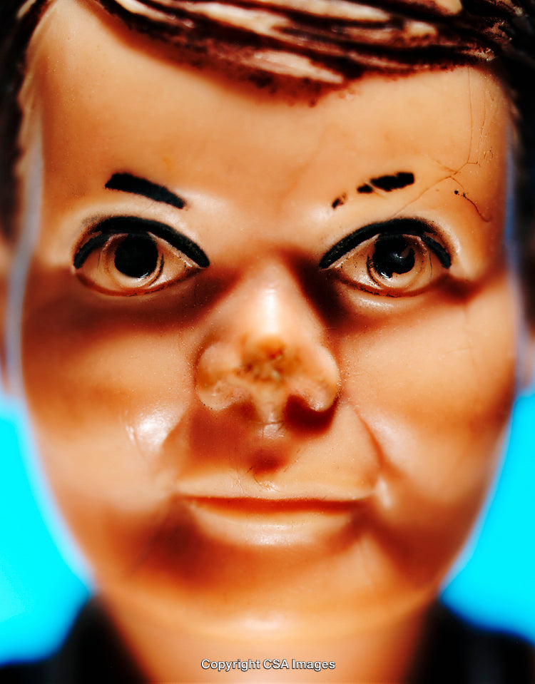 Close-Up of Vintage Plastic Toy Doll with Intense Expression