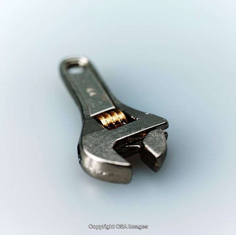 Close-Up View of an Adjustable Metallic Wrench on Isolated Background