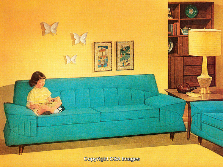 Retro Child Reading on a Vibrant Blue Sofa in a Cozy Living Room