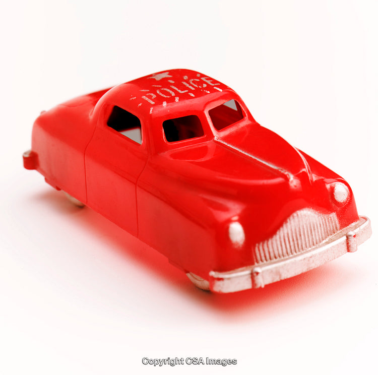 Red Vintage Toy Police Car Isolated on a White Background