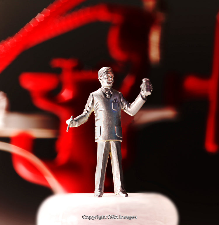 Silver Miniature Figure Displayed Against Red Abstract Background