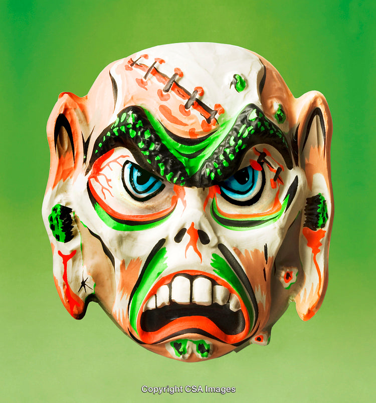 Colorfully Painted Monster Mask Against Vibrant Green Background