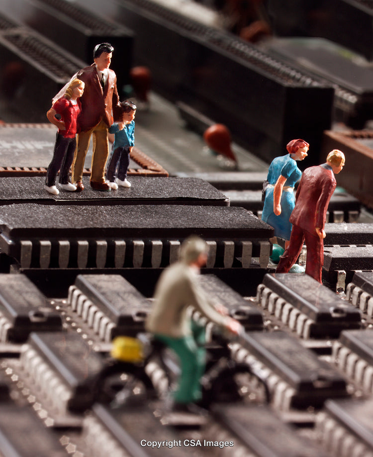 Miniature Figures Exploring a Complex Circuit Board Environment