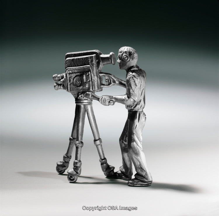 Silver Figurine of Cameraman Operating Vintage Film Camera on Tripod