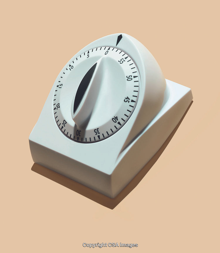 White Kitchen Timer Device Against a Neutral Background