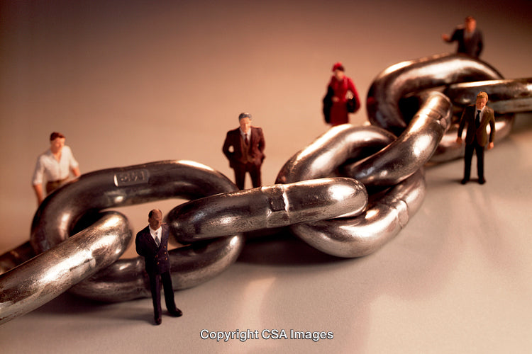 Miniature Business Figures with Chain Symbolizing Connection and Strength