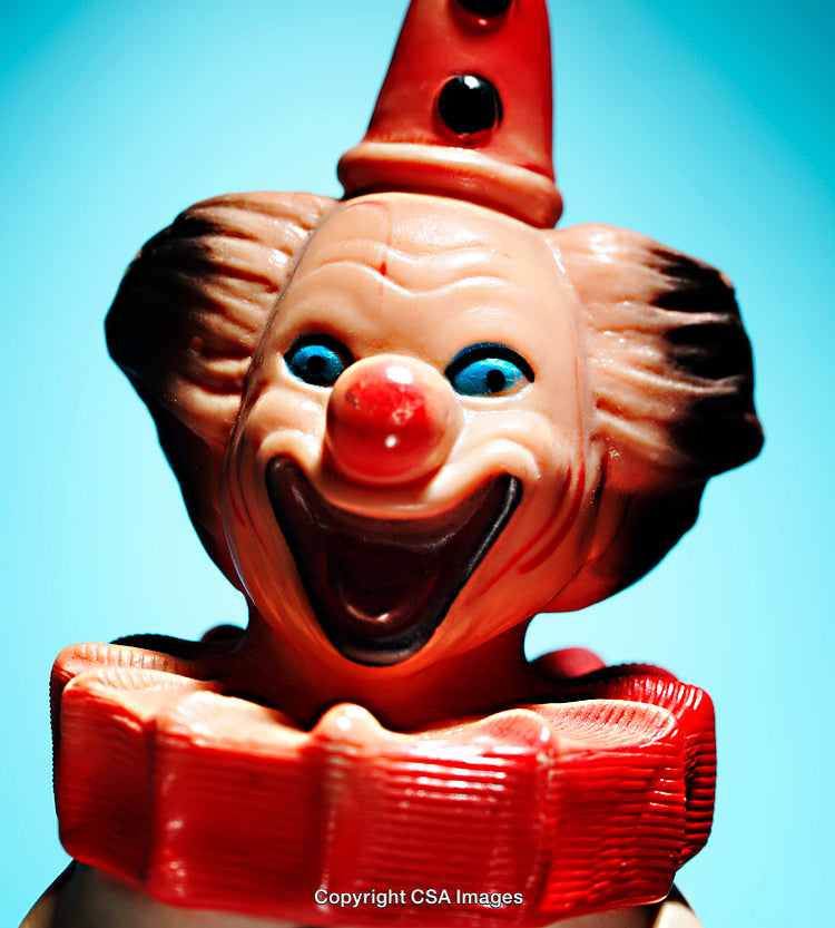 Close-Up of a Colorful Clown Toy Figurine in Bright Blue Background