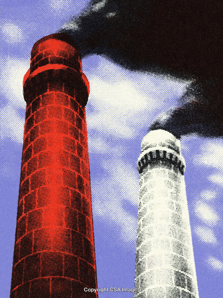Industrial Chimneys Emitting Smoke Against a Deep Blue Sky Background