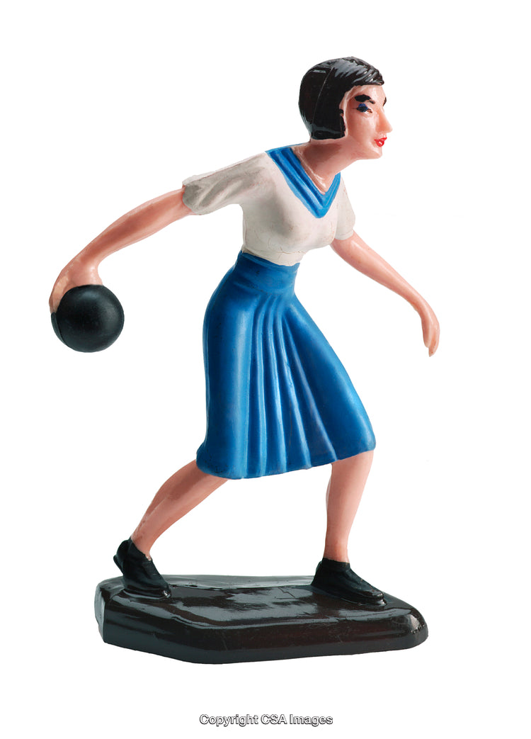 Vintage-Style Female Toy Figure Holding Small Black Ball in Action Pose