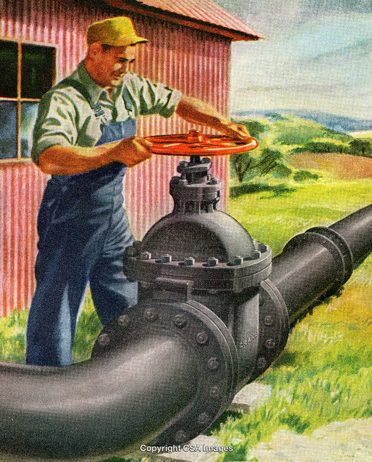 Worker Operating a Large Valve in an Outdoors Industrial Setting