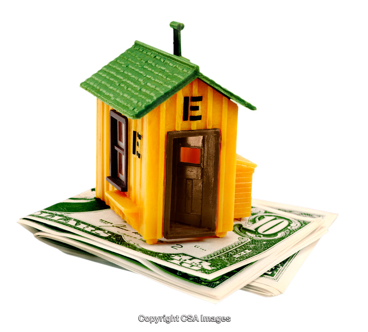 Toy House Model on Stack of Dollar Bills Symbolizing Real Estate Investments