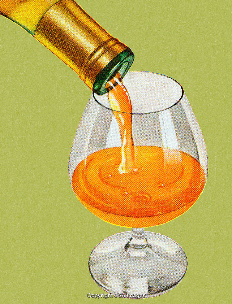 Golden Beverage Being Poured Into a Glass Against a Green Background