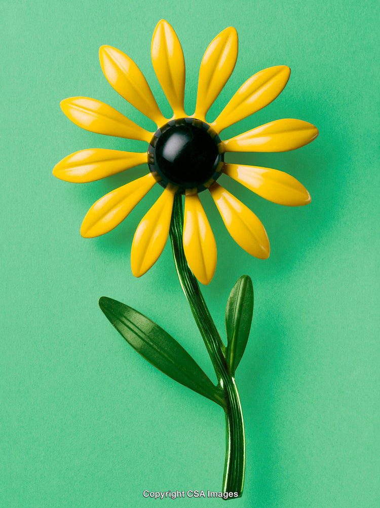 Bright Yellow Flower Toy on a Vibrant Green Background