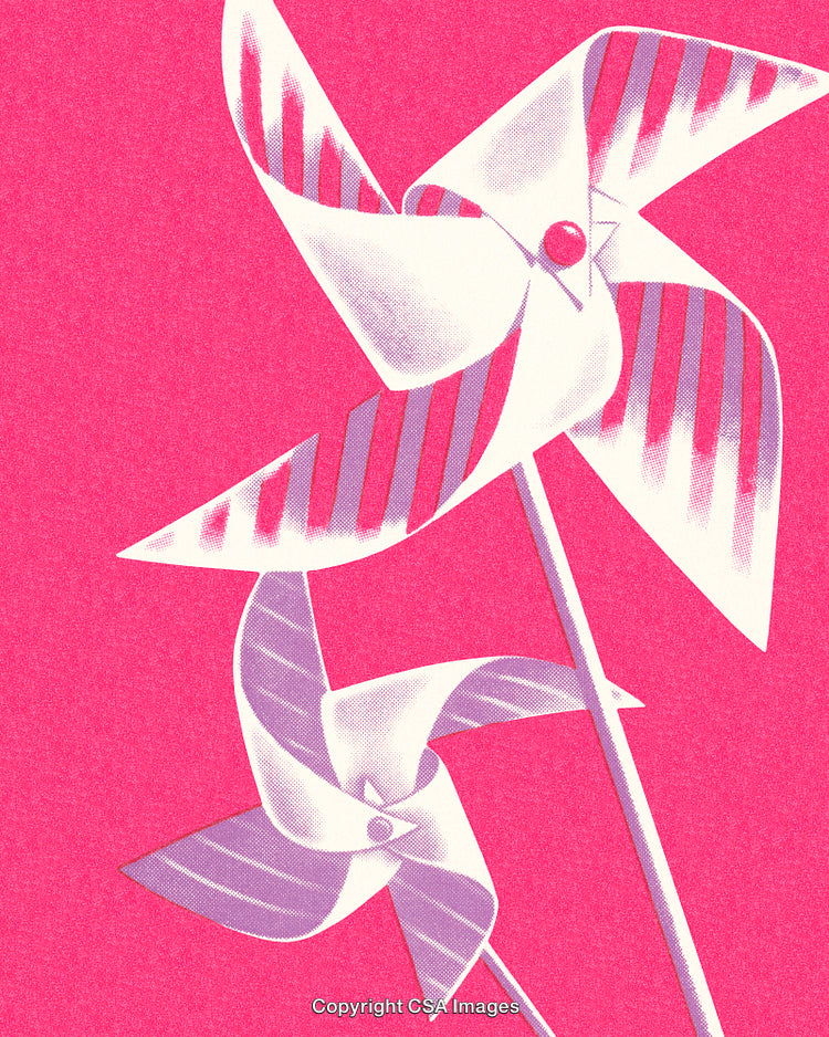 Colorful Pinwheels Displayed Against a Vibrant Pink Background