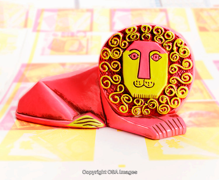 Vibrant Red Lion Figurine with Artistic Swirl Patterns on Display