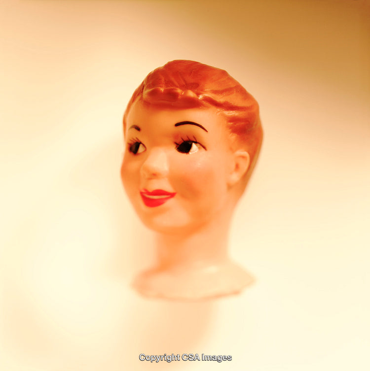 Close-Up of a Vintage Plastic Doll Head on Neutral Background