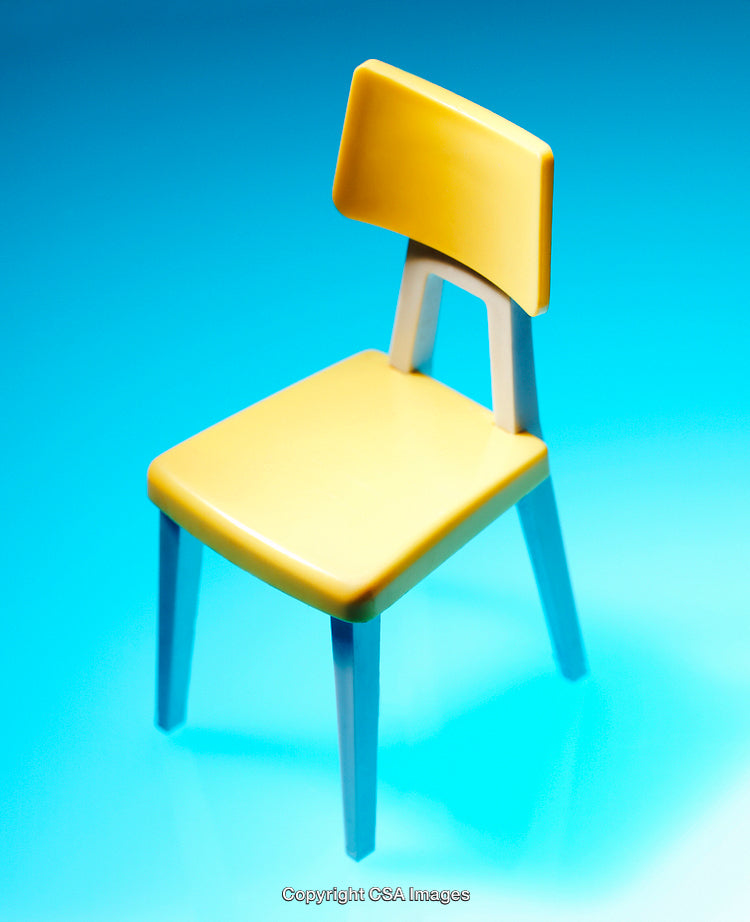Modern Yellow Toy Chair on Vibrant Blue Background