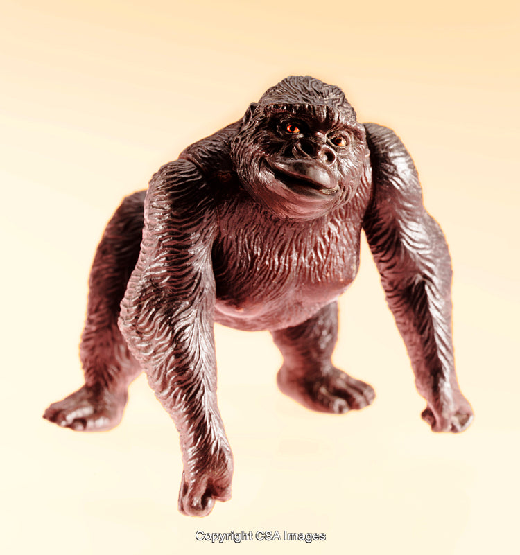 Close-Up of a Plastic Gorilla Figurine on Neutral Background
