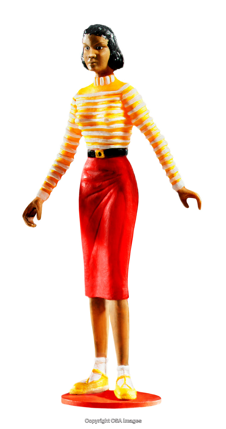 Plastic Figurine Wearing Red Skirt and Striped Yellow Shirt on White Background