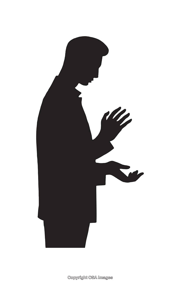 Silhouette of a Man Observing Reverence in a Spiritual Pose