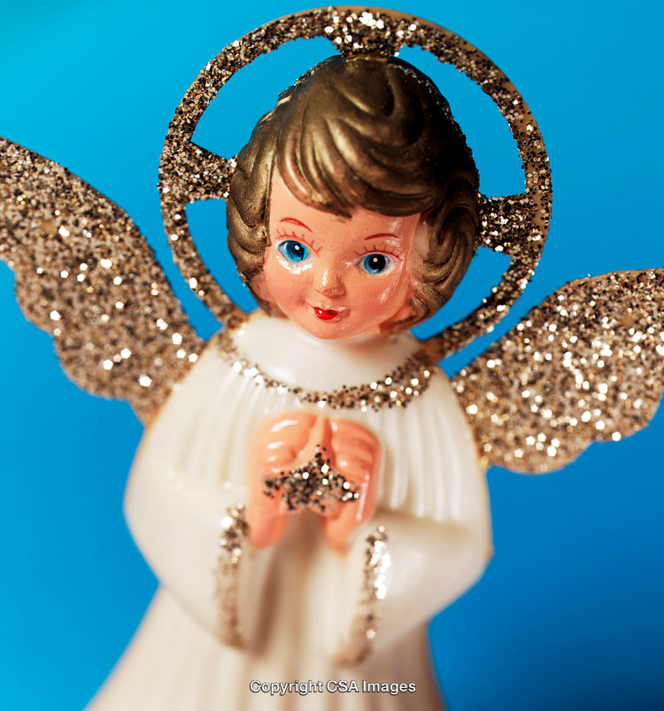 Vintage Angel Figurine With Glitter Wings Against a Bright Blue Background